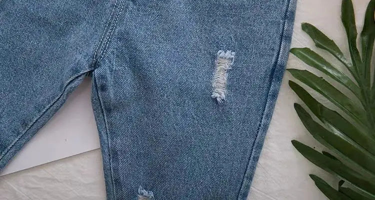 Fashionable ripped denim jeans, essential children's clothing for spring/autumn
