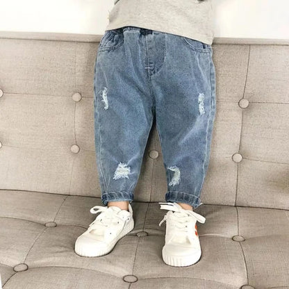 Close-up of ripped detail on toddler denim jeans, children's spring/autumn fashion