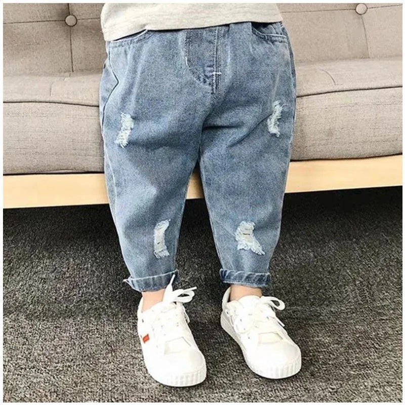 Toddler boy wearing stylish ripped denim jeans, elastic waist kids casual pants