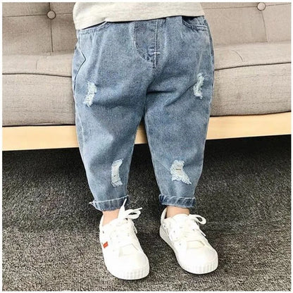 Toddler boy wearing stylish ripped denim jeans, elastic waist kids casual pants