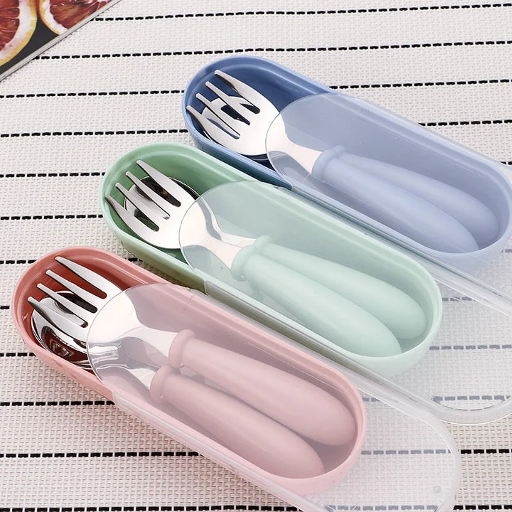 Ergonomic stainless steel fork and spoon from a cartoon toddler dinnerware set. Easy for little hands.