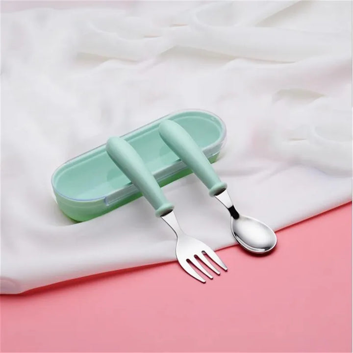 Overhead shot of a complete pink toddler stainless steel dinnerware set. Ideal for baby feeding.