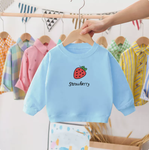 Close-up of the charming strawberry print on a high-quality cotton kids' sweater