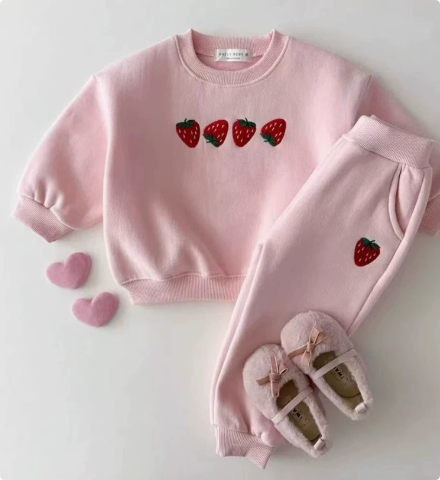 Toddler wearing a comfortable cotton strawberry sweater, children's fashion, happy child