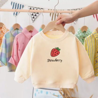 Detail of the crewneck collar on a soft cotton toddler sweater with strawberry motif