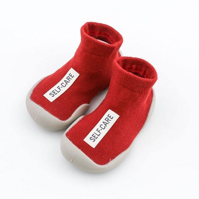 Textured soft-sole sock shoe for toddlers in a light yellow, ideal for home and nursery