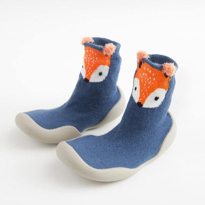 Overhead shot of two pairs of soft-sole infant sock shoes, pink and blue versions