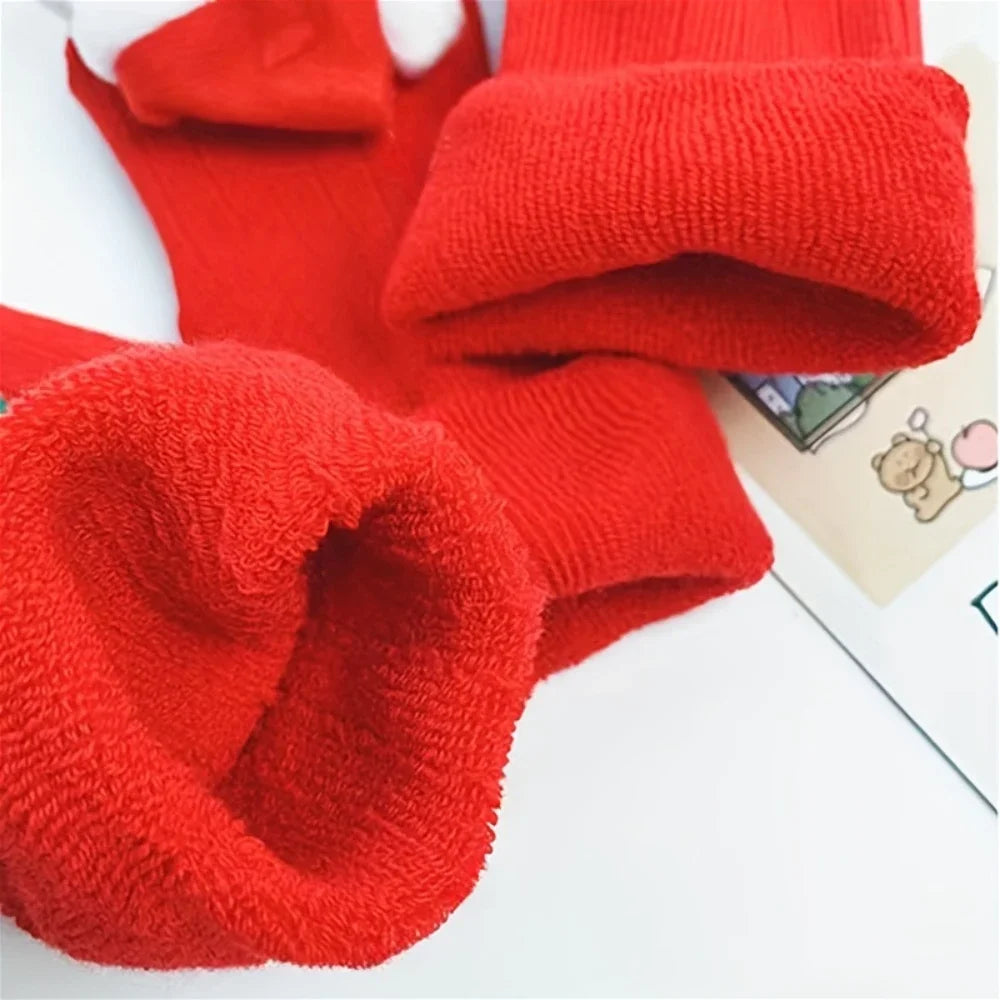 Pair of cheerful toddler anti-slip Santa socks, perfect festive wear for baby's holiday comfort.
