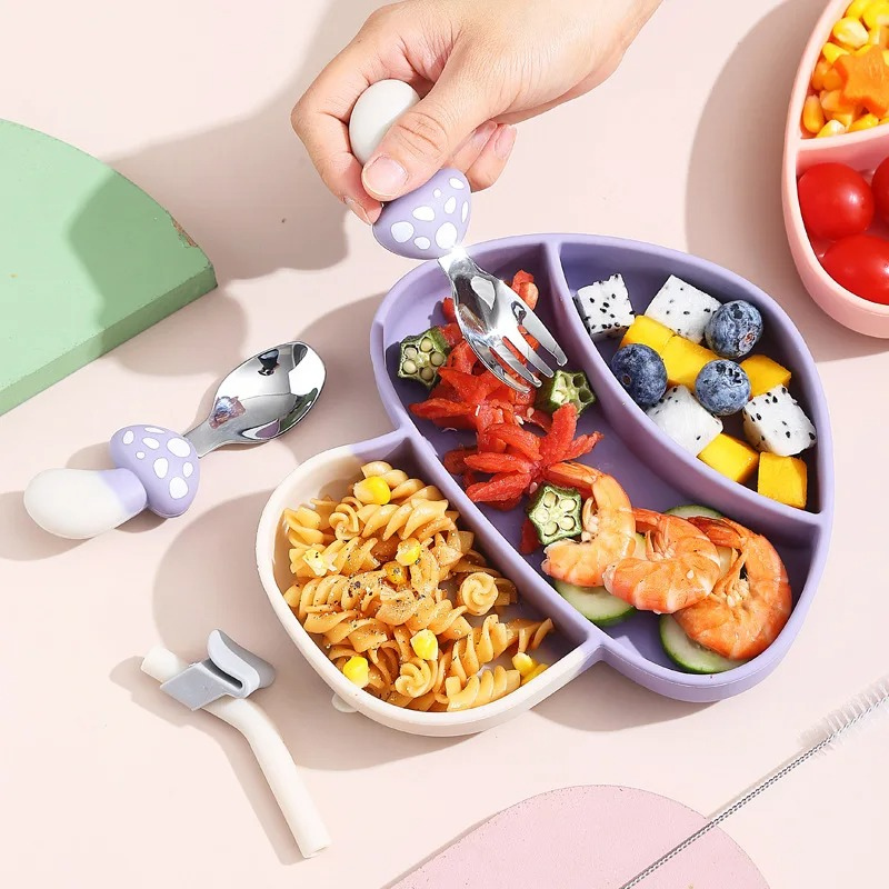 Toddler self-feeding silicone suction plate in green, non-slip base for easy mealtime for kids