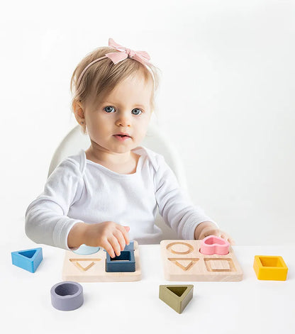 Toddler engaged in problem-solving with a silicone geometric matching board toy