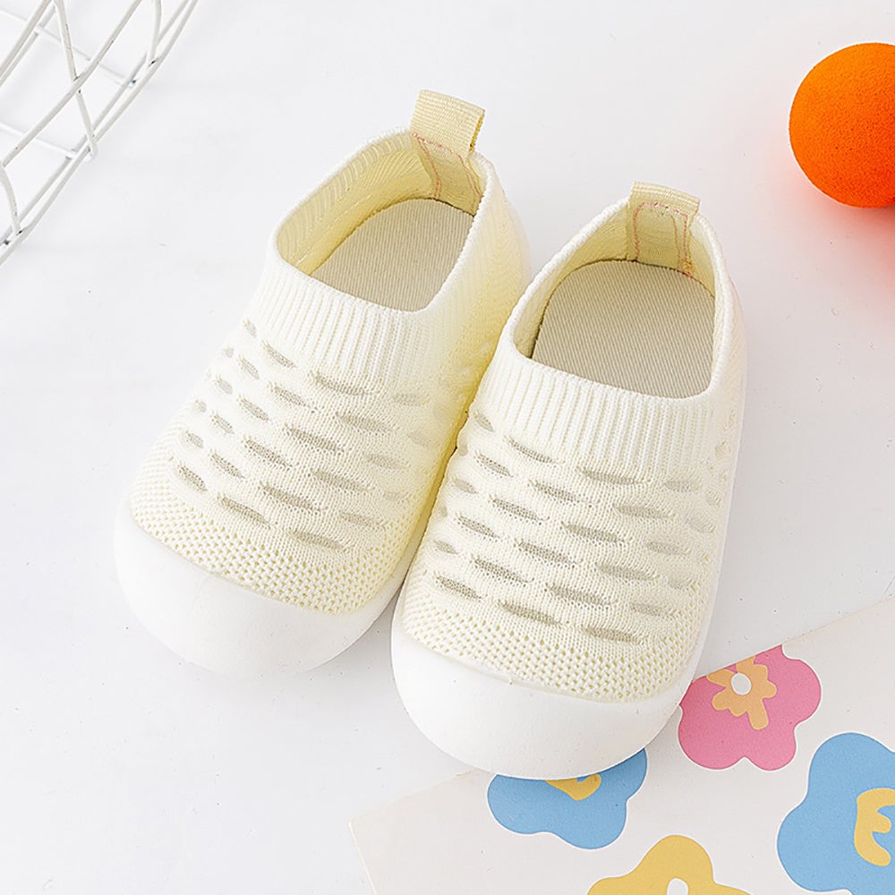 Close-up of the anti-slip sole on a blue toddler shoe, promoting child development safely.