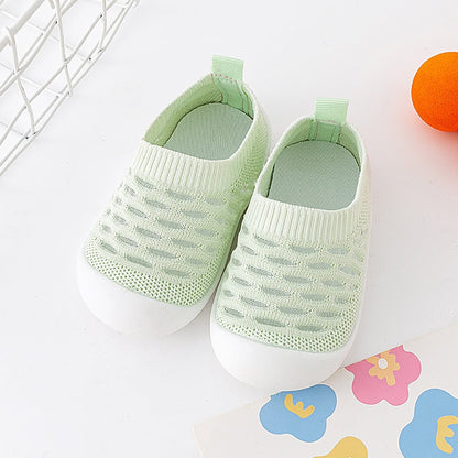 Overhead shot of two pairs of comfortable kids footwear, ready for infant comfort.