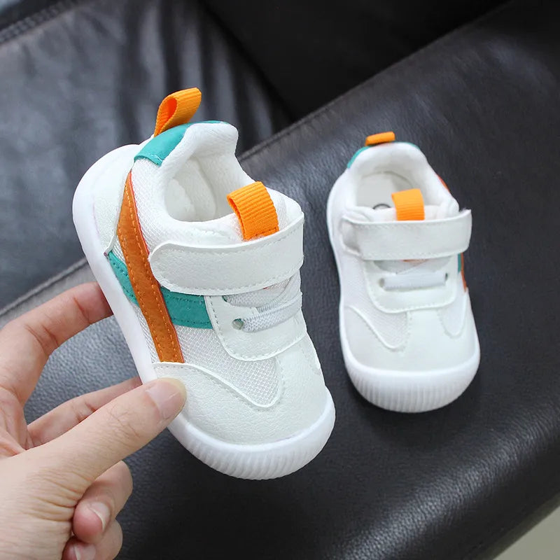 Pair of baby toddler sneakers, featuring a soft, flexible sole and non-slip traction.