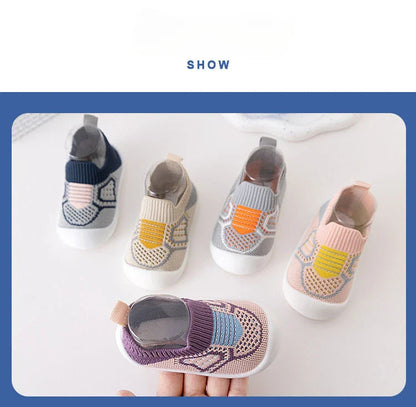 Soft sole baby shoes with elastic openings, ensuring a secure yet comfortable fit for tiny feet.
