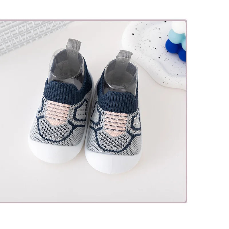 Baby leisure shoes with flexible soft soles, and an elastic band, ideal for developing feet.