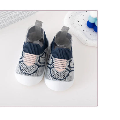 Baby leisure shoes with flexible soft soles, and an elastic band, ideal for developing feet.