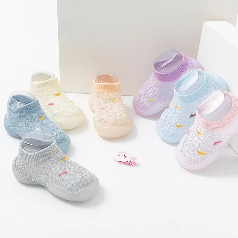 Pair of baby walking shoes, pink soft sole non-slip, for infants learning to walk.