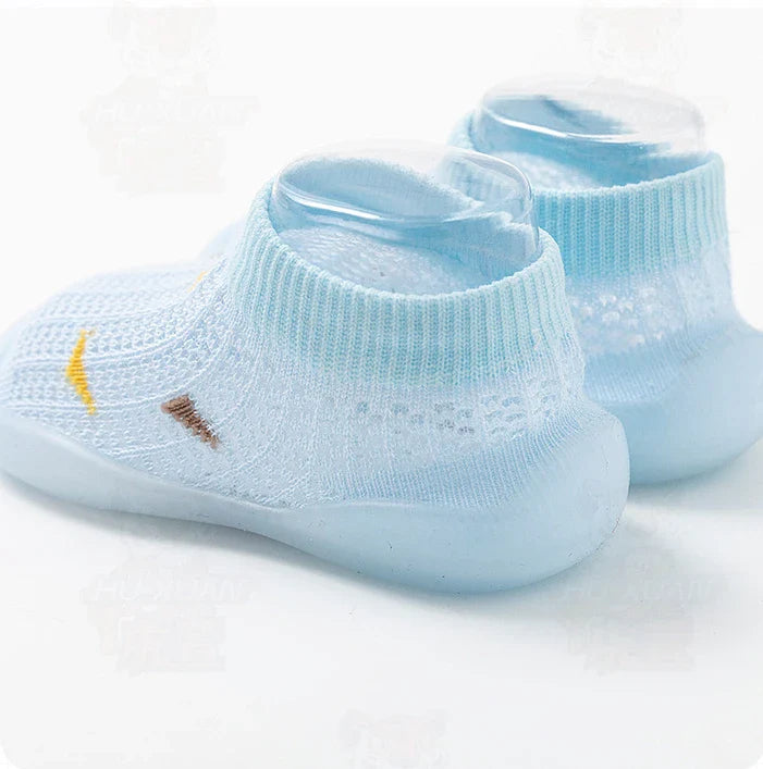 Close-up of a blue toddler soft sole shoe, non-slip grip, ideal for first steps.