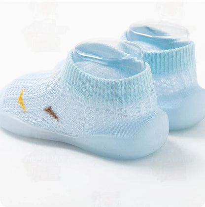 Close-up of a blue toddler soft sole shoe, non-slip grip, ideal for first steps.