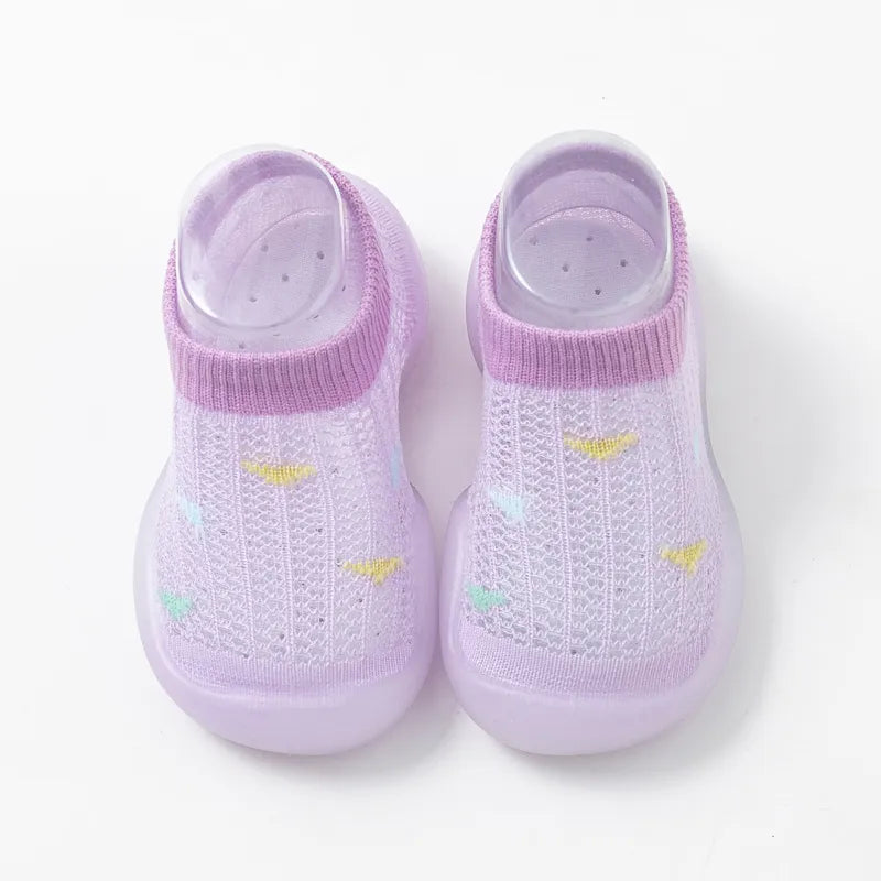 Rear view of grey soft sole toddler shoes, non-slip grip, supportive first steps.