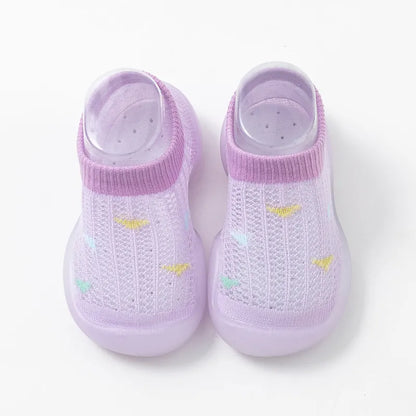 Rear view of grey soft sole toddler shoes, non-slip grip, supportive first steps.