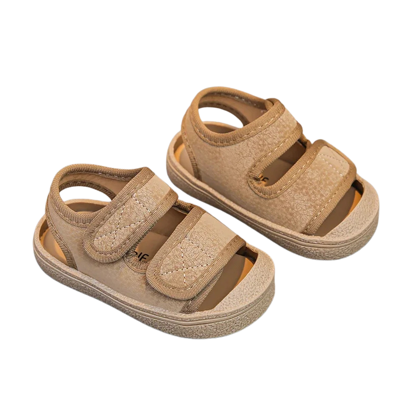 Pair of breathable toddler velcro sandals in a neutral color, suitable for both boys and girls