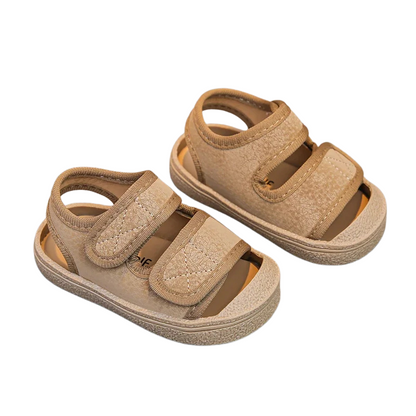 Pair of breathable toddler velcro sandals in a neutral color, suitable for both boys and girls