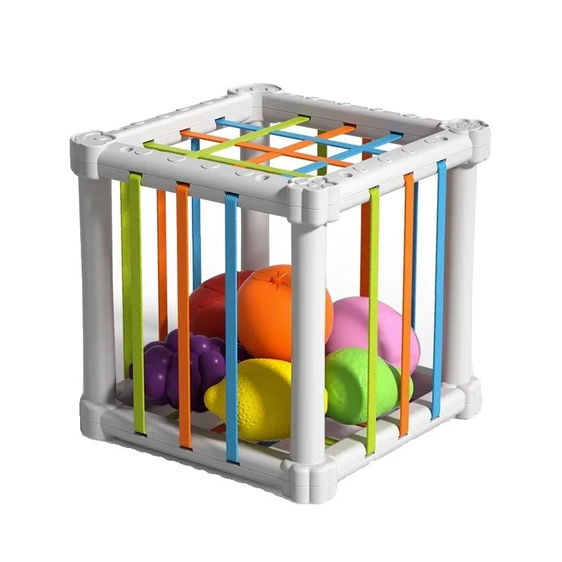 Child engaged in pretend play, placing a red apple into the fruit sorting educational toy.