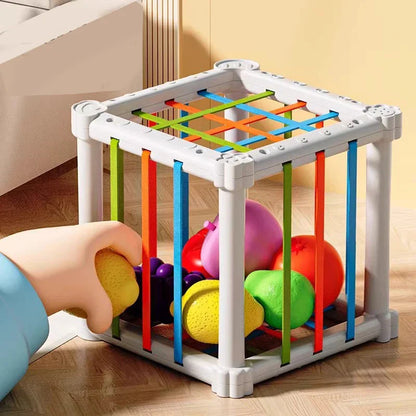 Wooden educational toy, a fruit sorting box, with various fruit pieces for toddler learning.