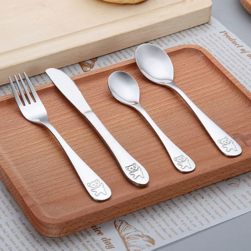 Close-up of toddler's stainless steel fork and spoon, durable kids tableware for weaning.
