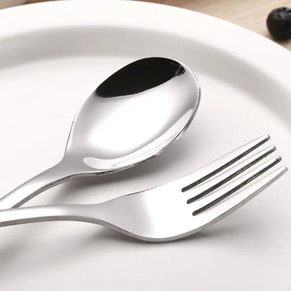 Four-piece toddler feeding set: stainless steel fork, spoon, knife, and small spoon, for weaning.