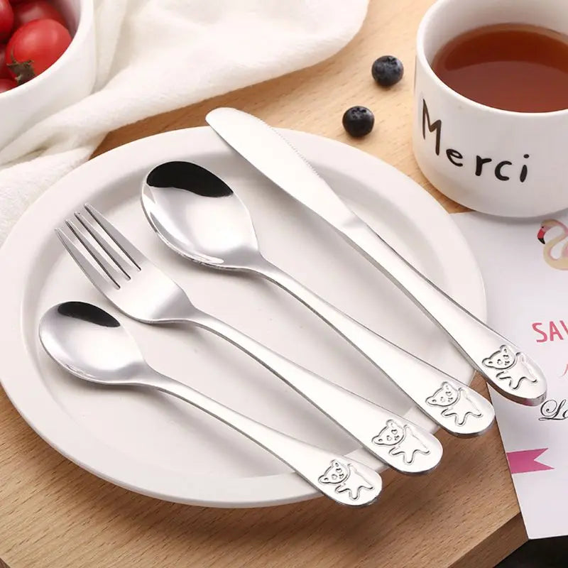 Toddler self-feeding set with ergonomic handles, stainless steel & BPA-free for kids.