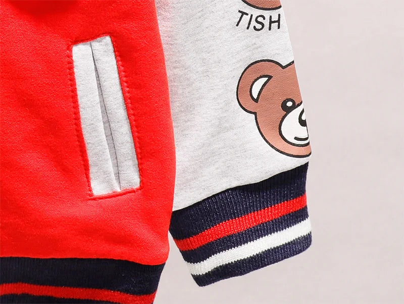 Detailed shot of button closure on a unisex toddler cartoon cotton jacket, secure fit