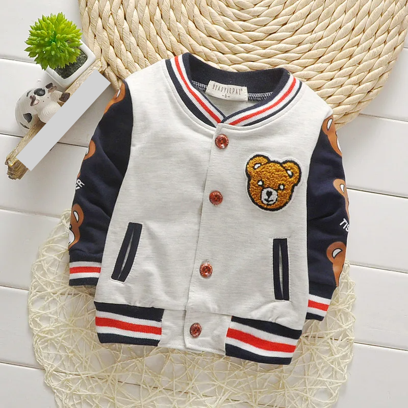 Child playing outdoors wearing a durable toddler unisex cartoon cotton jacket, fall season