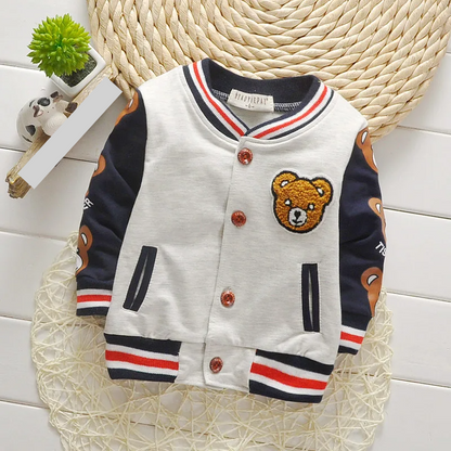Child playing outdoors wearing a durable toddler unisex cartoon cotton jacket, fall season