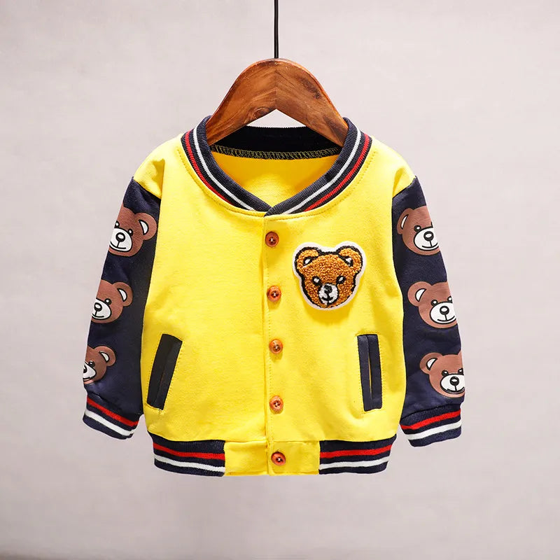 Toddler wearing a yellow cartoon cotton jacket, smiling, unisex children's fashion piece