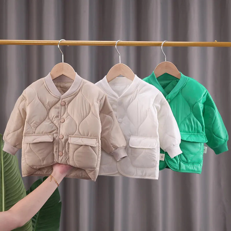 Adorable baby wearing a V-neck winter coat, ideal for outdoor play, unisex baby clothing