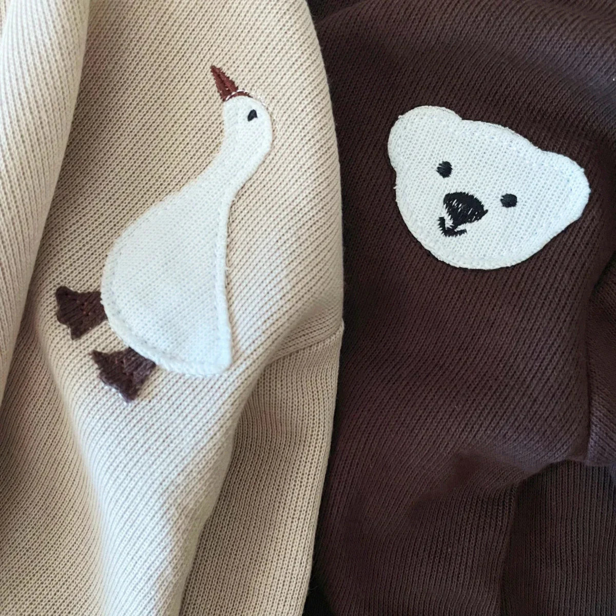 Close-up of soft fabric on a toddler bear & goose themed cotton tracksuit, ideal for comfort.