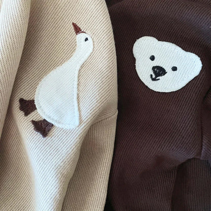 Close-up of soft fabric on a toddler bear & goose themed cotton tracksuit, ideal for comfort.
