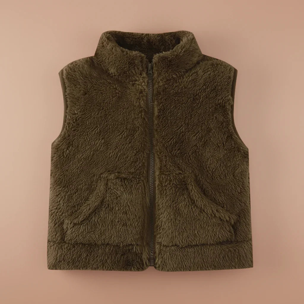 Toddler playing outdoors in a reversible fleece vest, durable warm outerwear for infants, fun kids vest