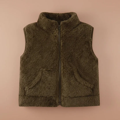 Toddler playing outdoors in a reversible fleece vest, durable warm outerwear for infants, fun kids vest