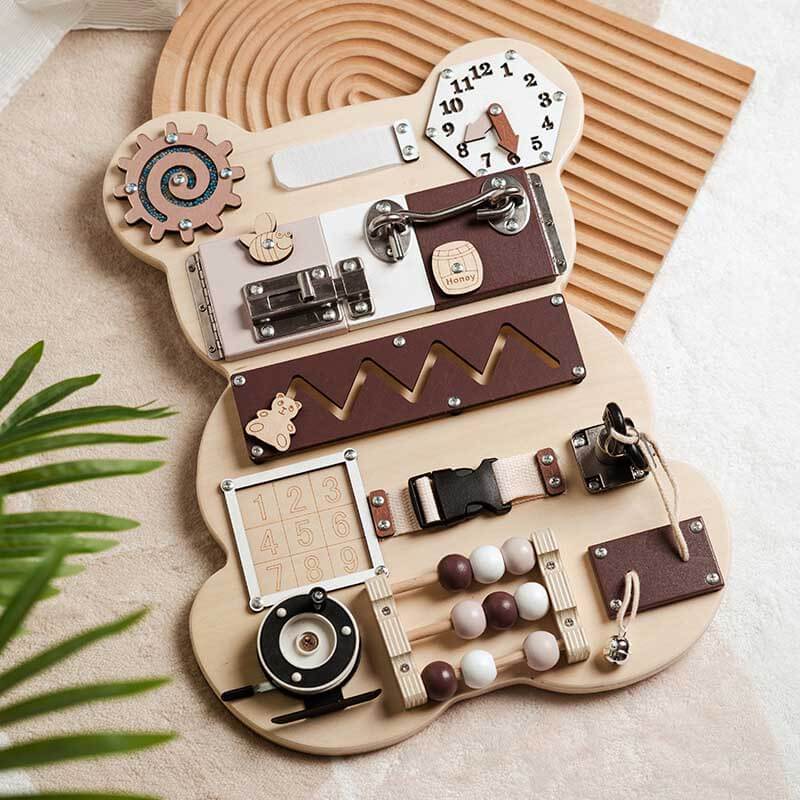 Educational wooden busy board for toddlers, featuring latches, gears, and a maze