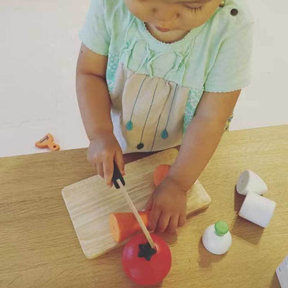 Wooden toy fruit set for toddlers, encouraging fine motor skills with pretend cutting