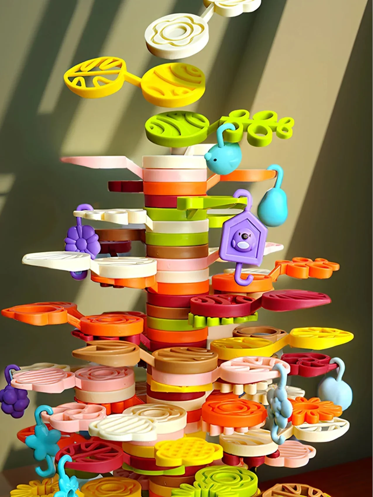 Rainbow tree blocks arranged in a unique stack, showcasing this educational building toy for kids' creative development.