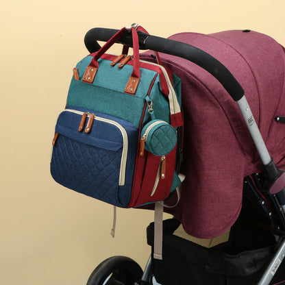 Diaper bag featuring a fold-out portable baby bed, ensuring comfort & convenience while traveling.