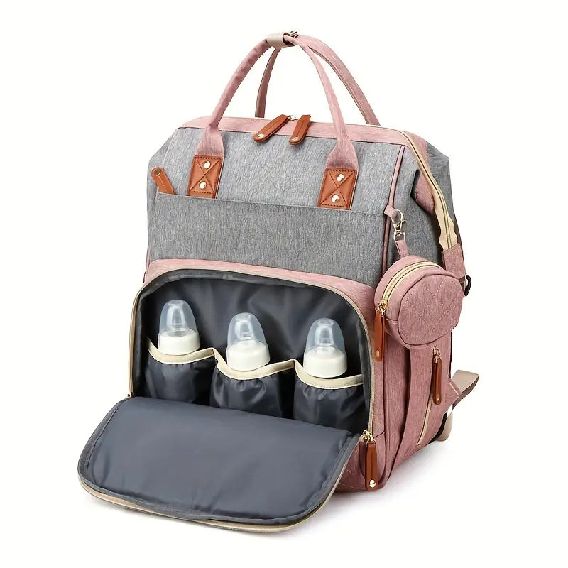 Travel diaper bag with stroller straps, offering a portable baby bed for nappy changes & rest.