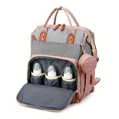 Travel diaper bag with stroller straps, offering a portable baby bed for nappy changes & rest.