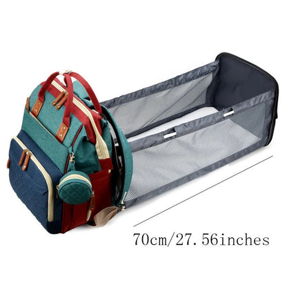 Detailed shot of the portable baby bed within the travel diaper bag, showing soft mattress.