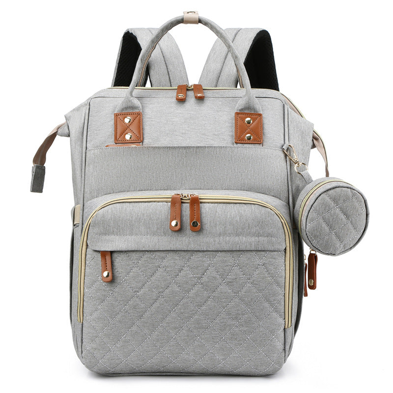 Innovative travel diaper bag that serves as a portable crib, perfect for travel & everyday use.