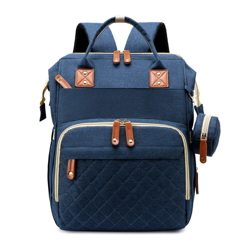 Multifunctional travel diaper bag with integrated baby bed, secure & comfy for your little one.